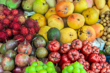 Various kinds of tropical fruit at the traditional market fruit seller's stall