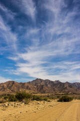 Dramatic desert mountains with high altitude Cirrus clouds in the /Ais-/Ais Richtersveld transfrontier park, in Southern Namibia.