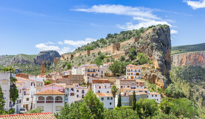 Fototapeta premium White village in front of the historic castle walls in Chulilla, Spain