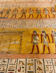 Ancient Egyptian hieroglyphs on the walls of a pharaoh's tomb in the Valley of the Kings, Luxor,...