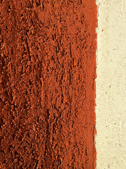 The texture of terracotta plaster on the wall in close-up