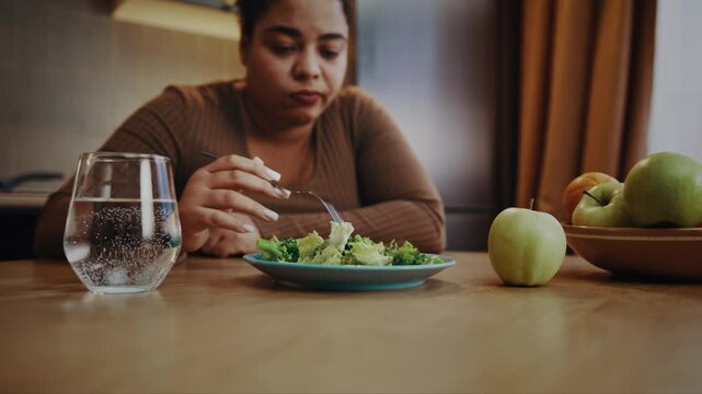 Sad woman reflects unwillingness to eat healthy salad