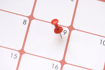 Calendar entry: Number 9 pinned with a red push pin or thumbtack, symbolizing the “Save the...