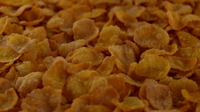 Macro video of corn flakes on rotating disc.