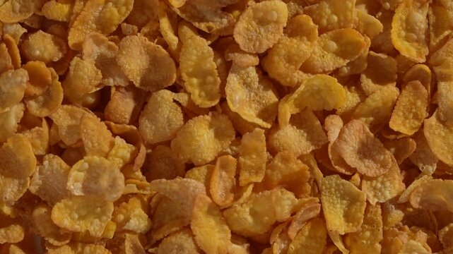 Macro video of corn flakes on rotating disc.