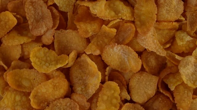 Macro video of corn flakes on rotating disc.