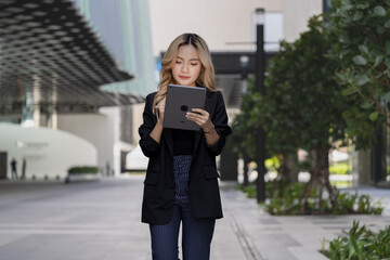 Businesswoman engaged in a digital task with a tablet and stylus, representing professionalism,...