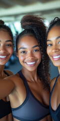 Three young African American women smiling confidently in a gym setting