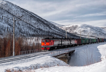 Train locomotive pulls wagons with cargo. Transportation industry