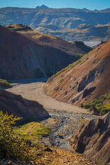 Obraz premium Vibrant rhyolite canyon Hvannagil in East Iceland's Seldalur Valley with colorful rock formations under a blue sky