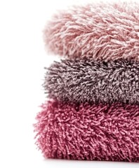 A detailed close-up view of neatly arranged towels showcasing their texture and colors against a clean white surface.