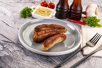 Delicous natural roasted sausages in the plate