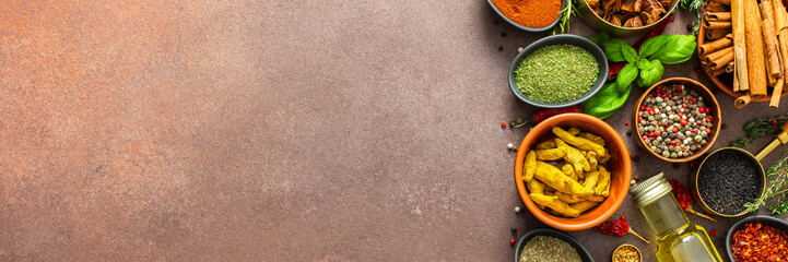 A visually striking arrangement of fresh spices and herbs on a brown surface, highlighting their vivid colors, intricate details, and rich culinary essence, banner