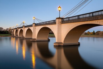 Elegant bridge at twilight, reflecting in calm river, park background, ideal for travel brochures