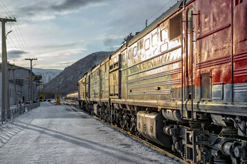 Train locomotive pulls wagons with cargo. Transportation industry