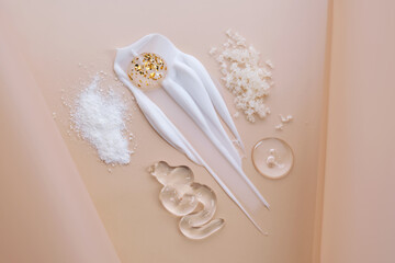 Different textures of cosmetic products on a beige background.