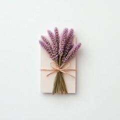 A delicate bouquet of lavender flowers elegantly tied to a white board, showcasing a blend of simplicity and natural beauty.