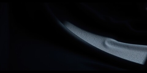 Dark Fabric Draped in Shadow, Showing Texture and Subtle Light