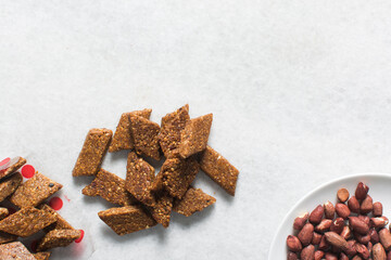 Overhead view of groundnut cake, top view of nkatie cake or peanut cake on a tray, candy bar made with roasted peanuts and sugar