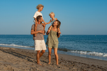 Happy Family Strolling Along the Beach..