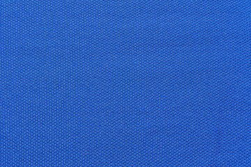 Close up textured blue fabric surface with knitted pattern.