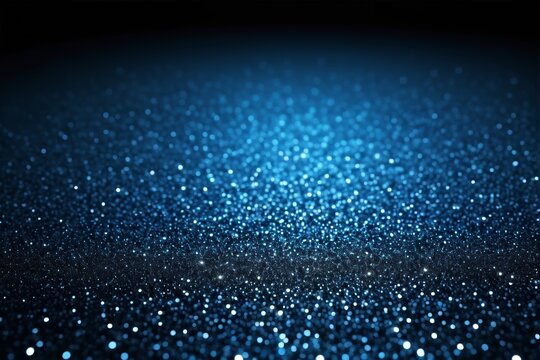 a close up of a blue glittery background with a black background