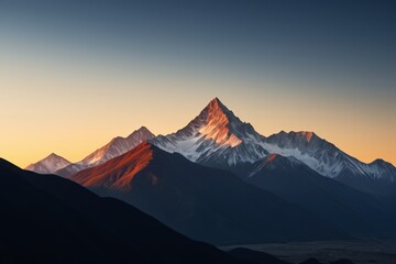 mountains with snow on them at sunset with a clear sky