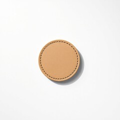 Round beige leather badge isolated. white background.