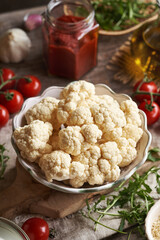 Ingredients for homemade gluten-free pizza - cauliflower, eggs, tomatoes and arugula
