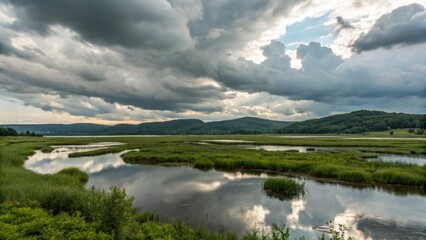 Obraz premium Serene Marsh Landscape Dramatic Clouds Reflected in Still Water, Wide Composition, Green Vegetation, Nature Photography Marsh, Landscape Photography