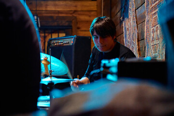 Drummer performs passionately at a heavy metal concert in an intimate venue