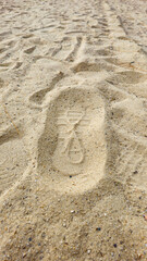 Closeup Shoe Print on the Sand at the Beach, mark left by a shoe on the surface of the sand. 