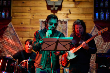 Heavy metal band performs live in an intimate venue with energetic atmosphere