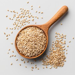 A close-up of sesame seeds in a wooden spoon, showcasing their texture and natural colors against a light background.