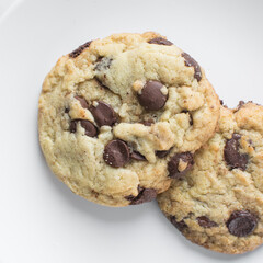 Overhead view of chocolate chip cookies on a white background, top view of homemade chocolate chip cookies