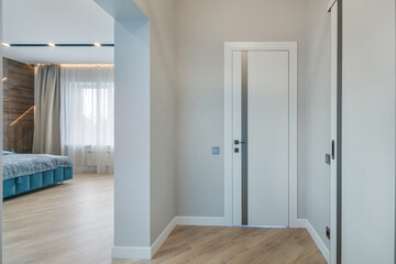 The interior of the apartment has a small corridor and a doorway to the bedroom with an elegant design.