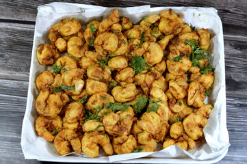 Fried shrimps covered with flour and fried in deep hot oil, shrimps are crustacean (a form of shellfish) with an elongated body and a primarily swimming mode of locomotion, Caridea or Dendrobranchiata