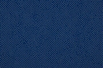 a close up of a blue fabric with white dots