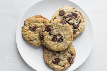 Overhead view of chocolate chip cookies on a white plate, top view of homemade chocolate chip cookies