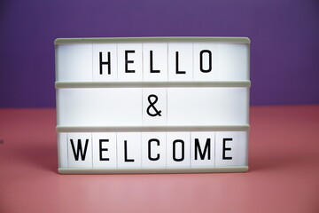 Hello & Welcome letterboard text on LED Lightbox on pink and purple background © may1985