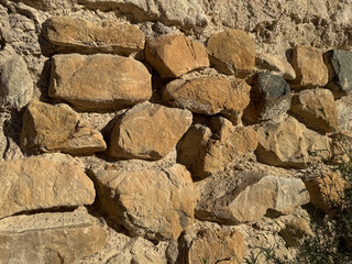 Vintage stone wall texture with rough rustic rocks and natural detail