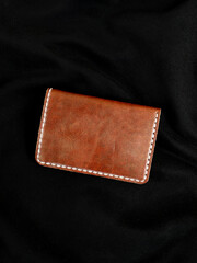 Blank brown leather wallet isolated on black background, perfect for leather industry catalog design