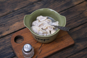 Homemade meat dumplings - russian pelmeni. Dumplings, filled with meat, ravioli.