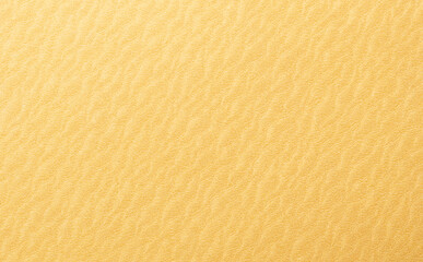 Golden yellow paper background with rippled, wavy textures and a smooth surface. Vibrant warm tones...