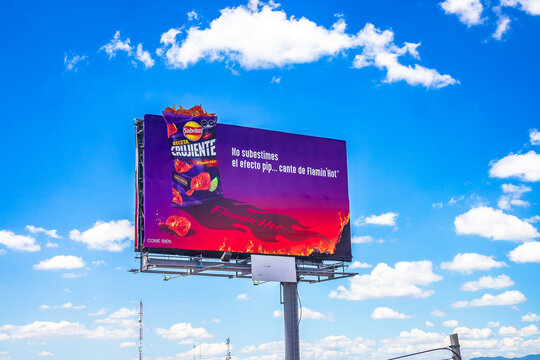 Queretaro, Queretaro Mexico, September 23 2024 Sabritas spicy potato chips advertising billboard on the road with a blue sky and clouds in the background, outdoor advertising or out-of-home advertisin
