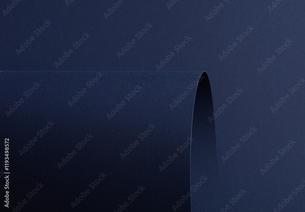 Poster midnight blue paper background with curved, matte surfaces and a smooth, grainy texture. bold dark t