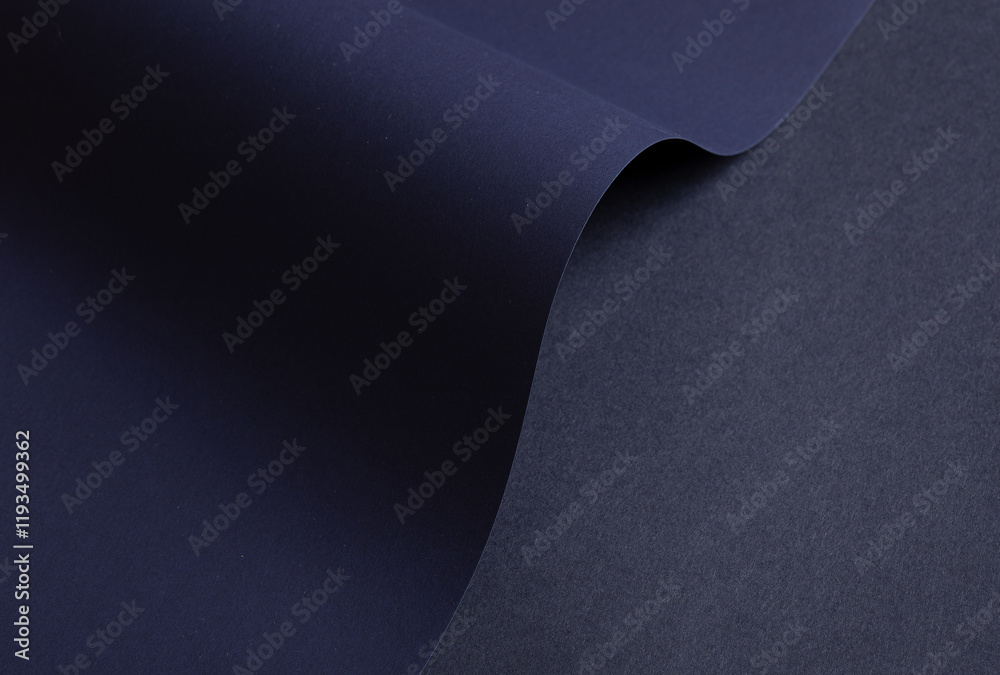 Poster midnight blue paper background with curved, matte surfaces and a smooth, grainy texture. bold dark t