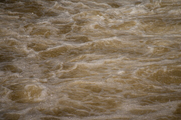 Close up of splashing and foaming water in river rapids.