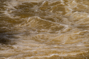 Close up of splashing and foaming water in river rapids.