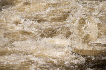 Close up of splashing and foaming water in river rapids.